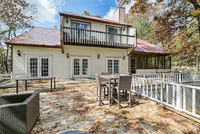 back of house featuring a deck, french doors, and a balcony