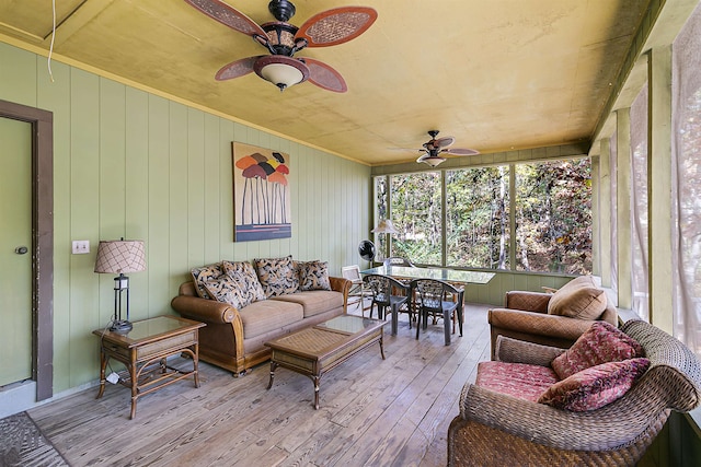 sunroom featuring ceiling fan