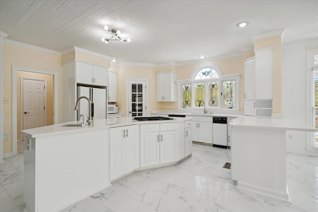 kitchen featuring ornamental molding, sink, white cabinets, white appliances, and a center island