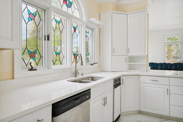 kitchen featuring dishwasher, sink, and white cabinets