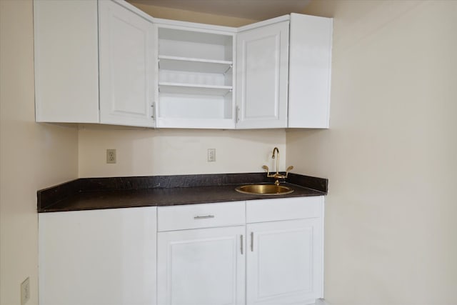 bar with sink and white cabinets