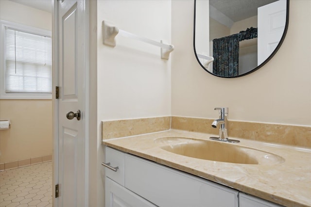 bathroom featuring vanity, a textured ceiling, and tile patterned floors