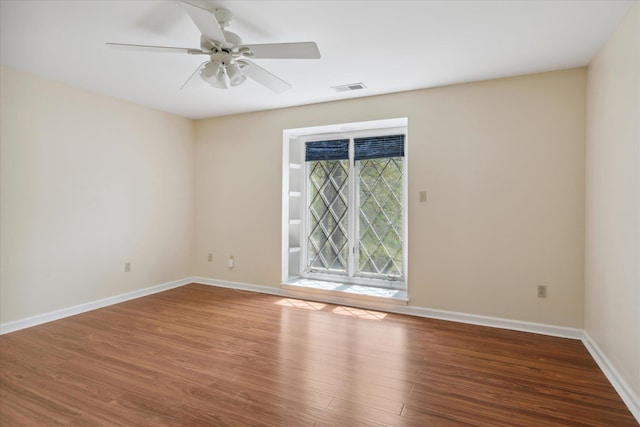 empty room with hardwood / wood-style floors and ceiling fan