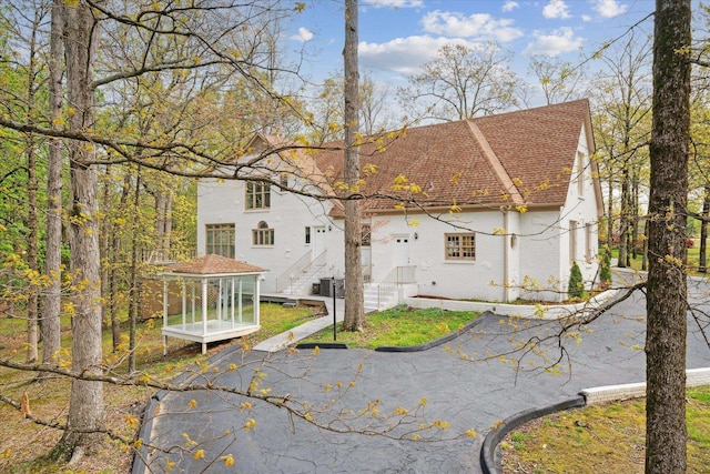 rear view of property featuring cooling unit