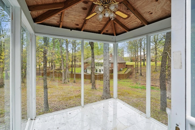 unfurnished sunroom with vaulted ceiling with beams, ceiling fan, and wooden ceiling