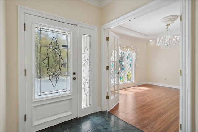 foyer with a chandelier, crown molding, dark hardwood / wood-style floors, and plenty of natural light