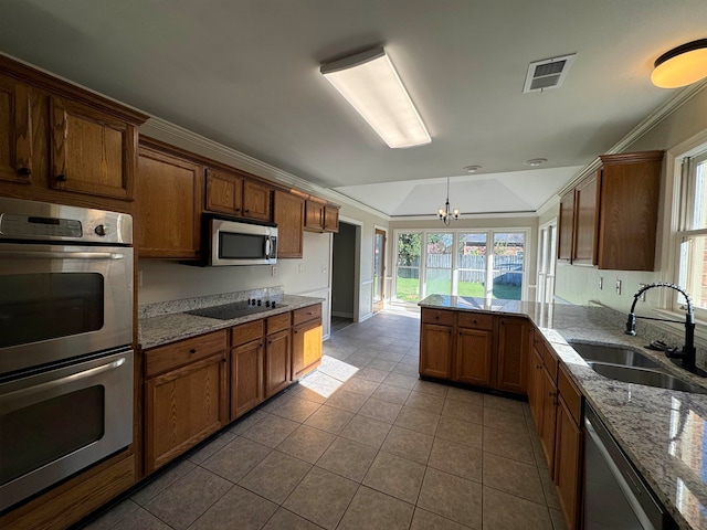 kitchen with pendant lighting, an inviting chandelier, crown molding, sink, and appliances with stainless steel finishes