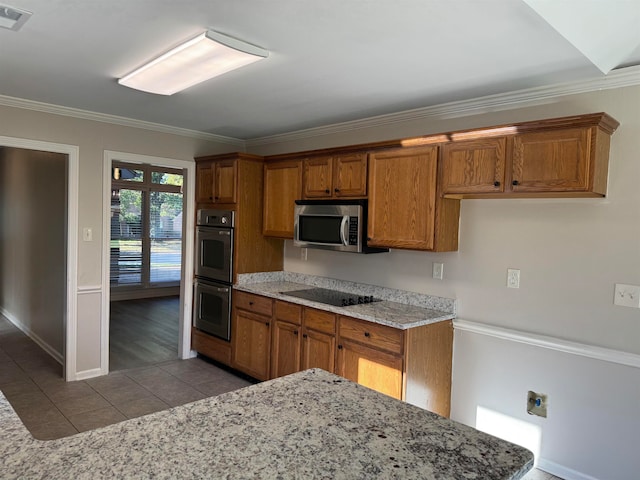 kitchen featuring crown molding, light tile patterned flooring, and appliances with stainless steel finishes