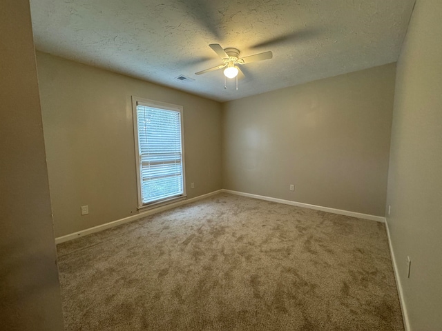 unfurnished room featuring carpet flooring, a textured ceiling, and ceiling fan