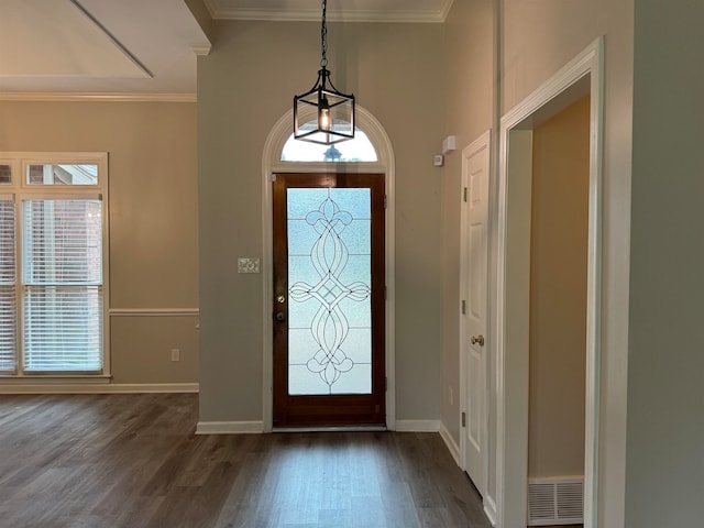 foyer entrance with crown molding and dark wood-type flooring