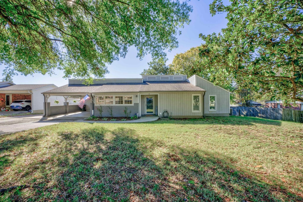 ranch-style home featuring a front yard and a carport