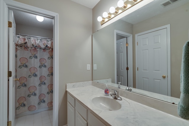 bathroom with vanity, tile patterned flooring, a textured ceiling, and a shower with curtain