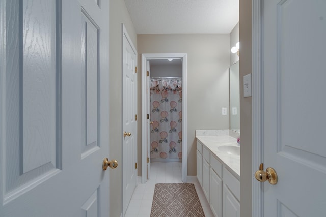 bathroom with vanity, a textured ceiling, tile patterned floors, and a shower with curtain