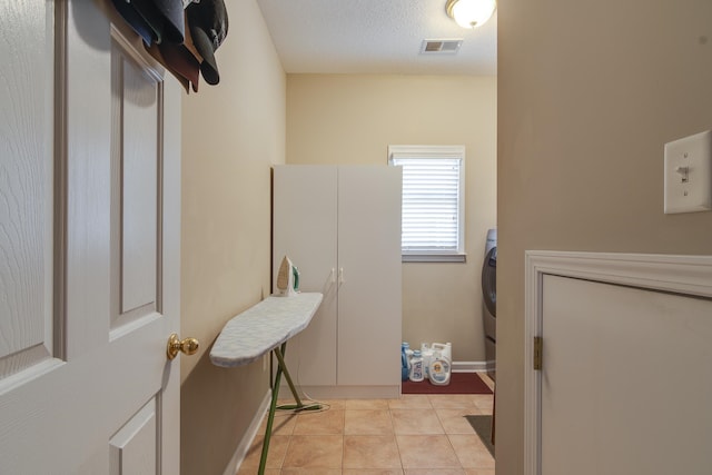 interior space featuring tile patterned flooring and a textured ceiling