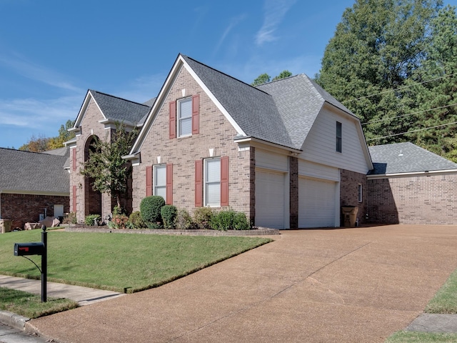 view of front property featuring a garage and a front yard