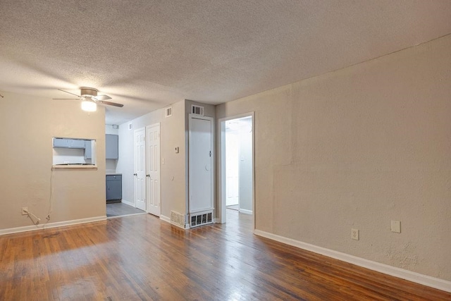 unfurnished room with dark wood-type flooring, ceiling fan, and a textured ceiling