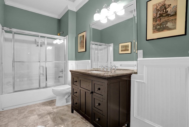 full bathroom featuring crown molding, combined bath / shower with glass door, vanity, and toilet