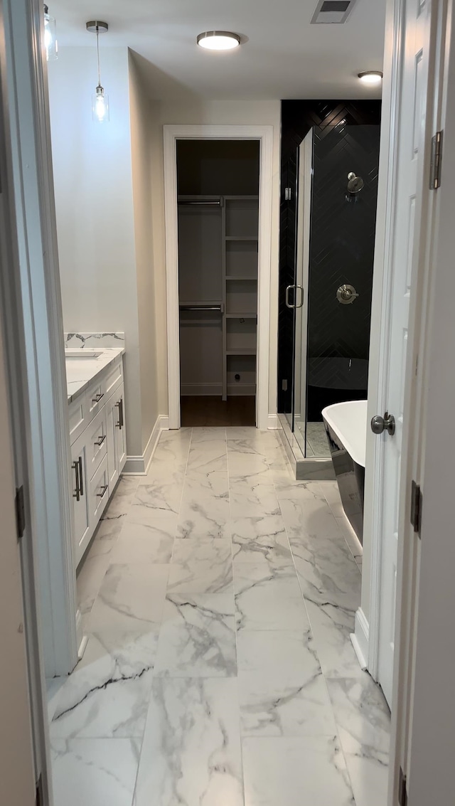 bathroom with vanity and separate shower and tub