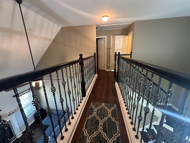 stairs featuring vaulted ceiling and hardwood / wood-style flooring