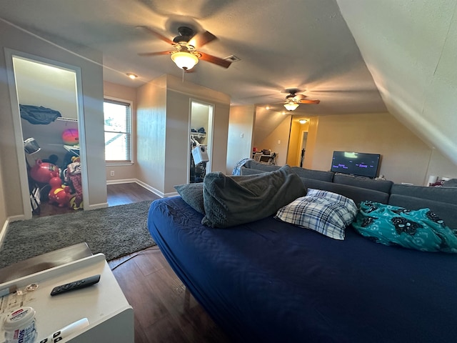 bedroom with dark wood-type flooring, a closet, vaulted ceiling, and ceiling fan