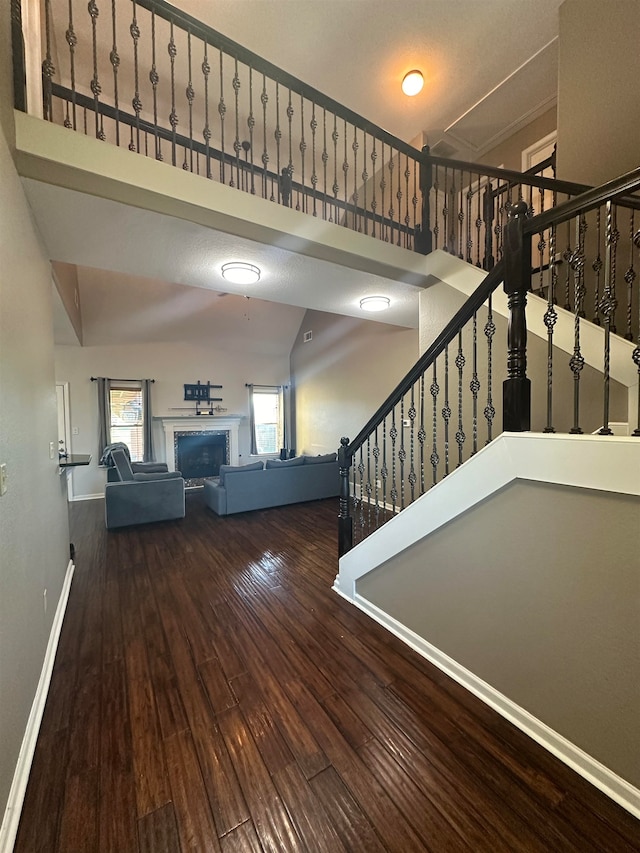 interior space with hardwood / wood-style flooring and vaulted ceiling