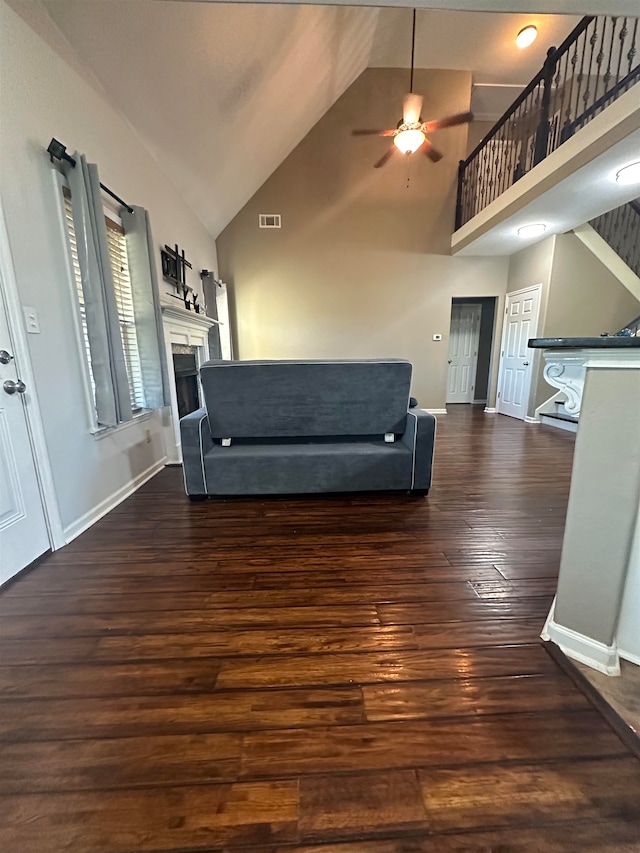 unfurnished living room featuring high vaulted ceiling, ceiling fan, and dark hardwood / wood-style floors