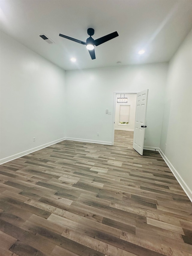 unfurnished bedroom with ceiling fan and dark hardwood / wood-style flooring