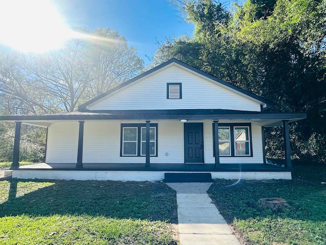 view of front of home featuring covered porch and a front lawn