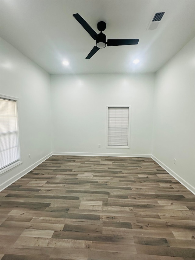 spare room with ceiling fan and dark hardwood / wood-style flooring