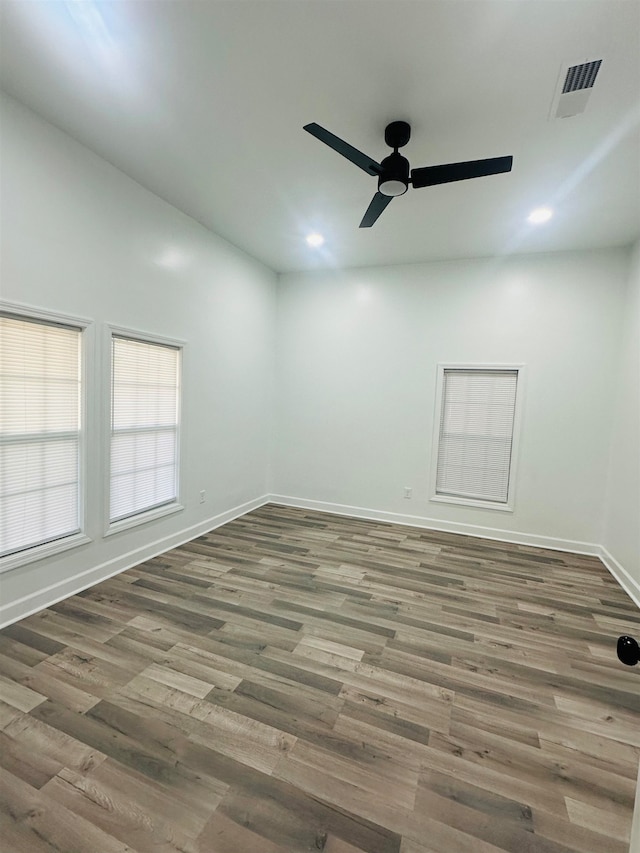 empty room featuring ceiling fan and dark hardwood / wood-style floors