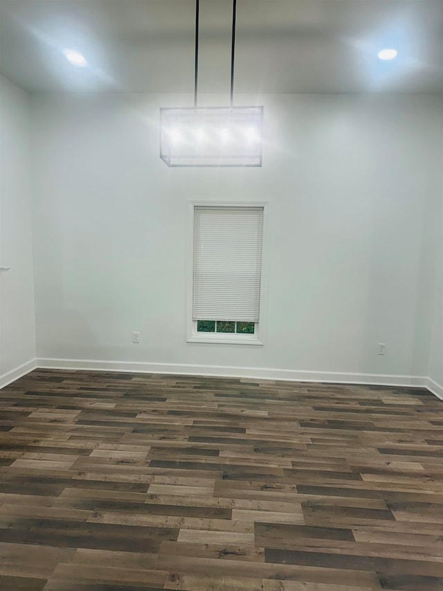 unfurnished room featuring dark hardwood / wood-style flooring