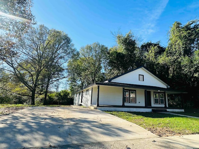 view of front of house with covered porch and a front yard