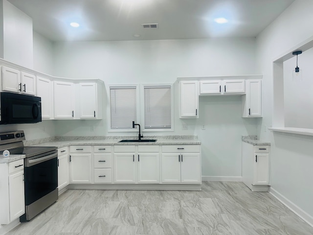 kitchen featuring white cabinets, electric stove, sink, decorative light fixtures, and light stone counters