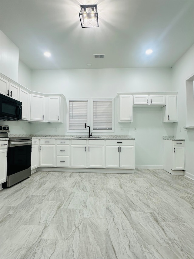 kitchen with white cabinetry, sink, and stainless steel range with electric stovetop