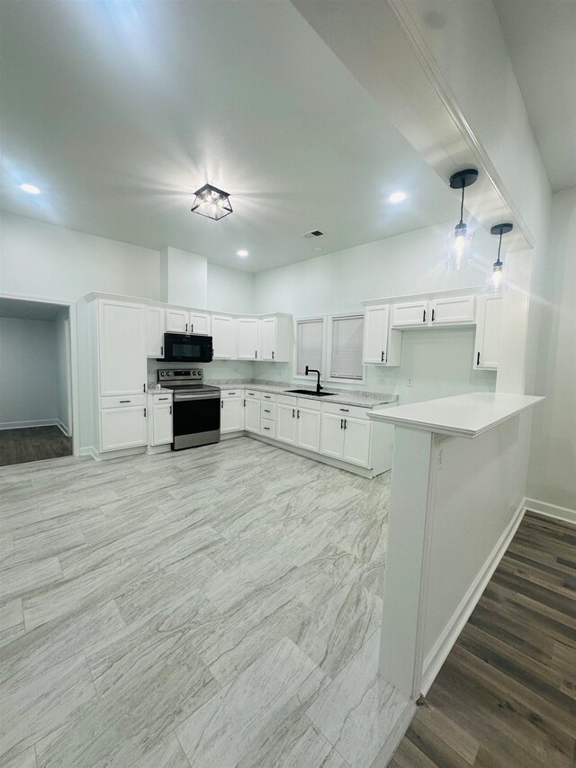 kitchen with sink, decorative light fixtures, white cabinetry, and electric stove