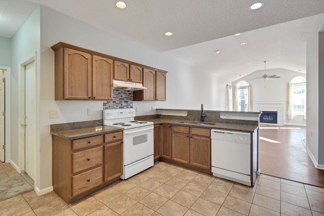 kitchen featuring sink, ceiling fan, light tile patterned floors, white appliances, and lofted ceiling