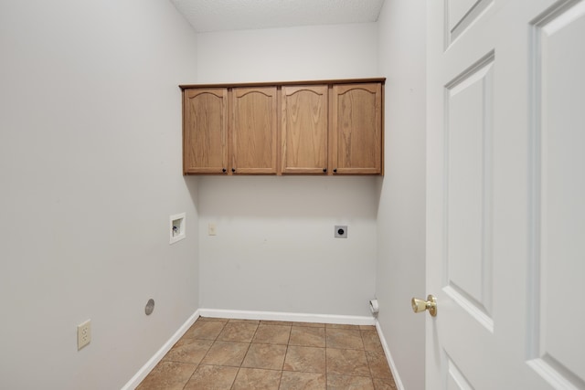 laundry room with light tile patterned flooring, hookup for an electric dryer, washer hookup, a textured ceiling, and cabinets