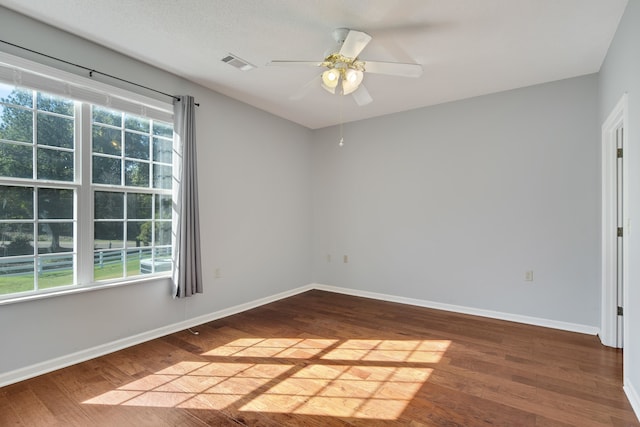 spare room featuring hardwood / wood-style flooring and ceiling fan