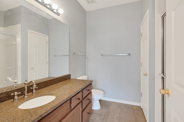 bathroom featuring tile patterned flooring, vanity, toilet, and a shower with shower door