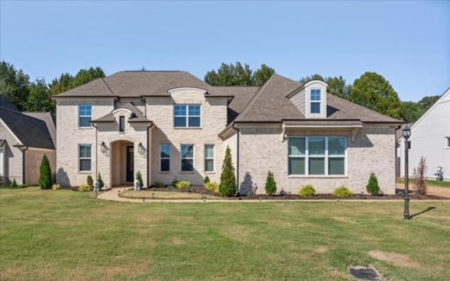 french provincial home featuring a front lawn