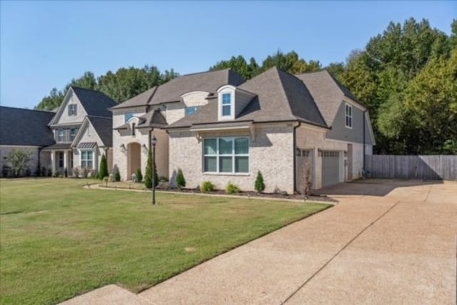 view of front of house featuring a garage and a front yard