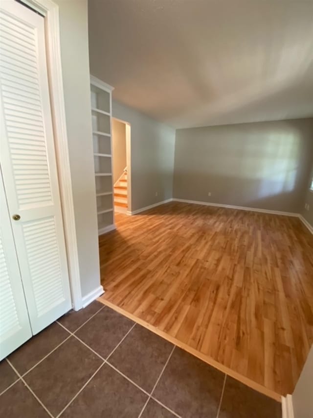 unfurnished living room with dark hardwood / wood-style floors