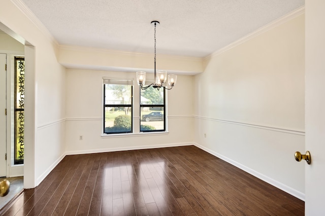 unfurnished dining area with dark wood-type flooring, a chandelier, a textured ceiling, and crown molding