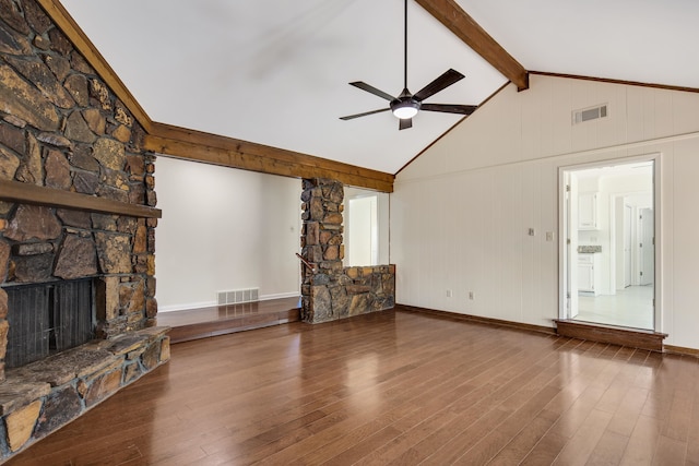 unfurnished living room with hardwood / wood-style floors, a fireplace, ceiling fan, and beam ceiling