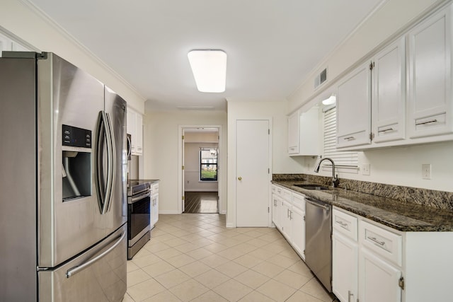 kitchen with white cabinets, sink, crown molding, and stainless steel appliances