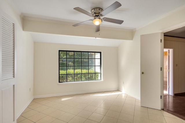 tiled spare room with ornamental molding, vaulted ceiling, and ceiling fan