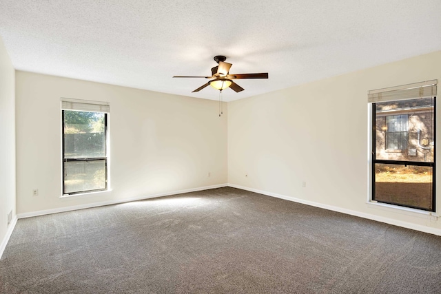 carpeted spare room featuring ceiling fan and a textured ceiling