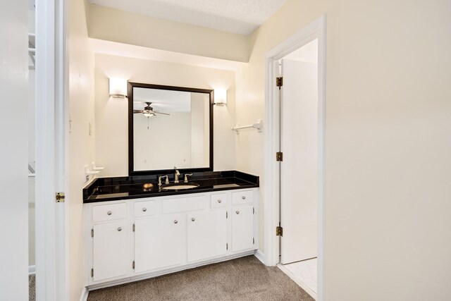 bathroom featuring vanity, a textured ceiling, and ceiling fan