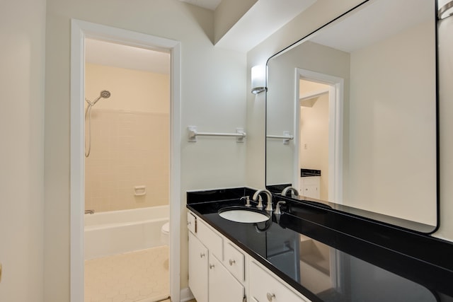 full bathroom featuring toilet, tiled shower / bath combo, vanity, and tile patterned flooring