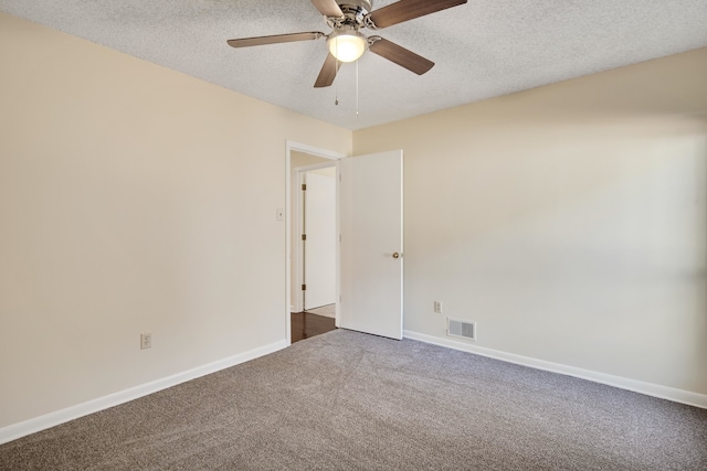 carpeted spare room with ceiling fan and a textured ceiling